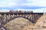 AT&SF, Santa Fe, C44-9W 650 - 763 -C40-8W 900 with an eastbound stack train crossing the steel arched bridge at Canyon Diablo, Arizona. April 12, 1998. 